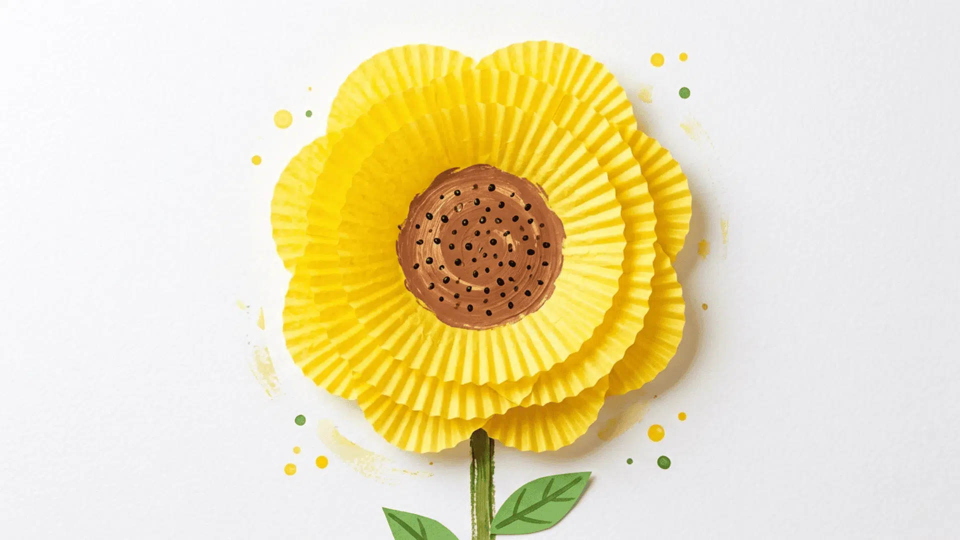 cupcake liner sunflower craft showing flattened yellow cupcake liners as petals around a brown painted center on white background