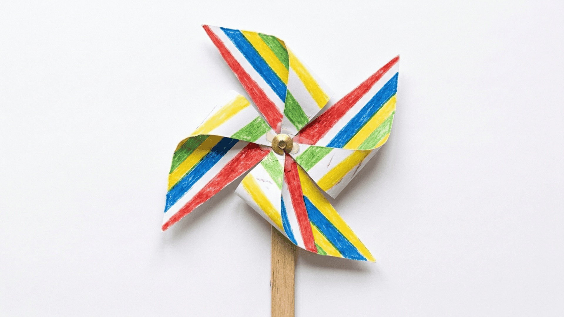 paper pinwheel craft showing a bold striped paper folded into a pinwheel shape with a gold brad on a wooden craft stick