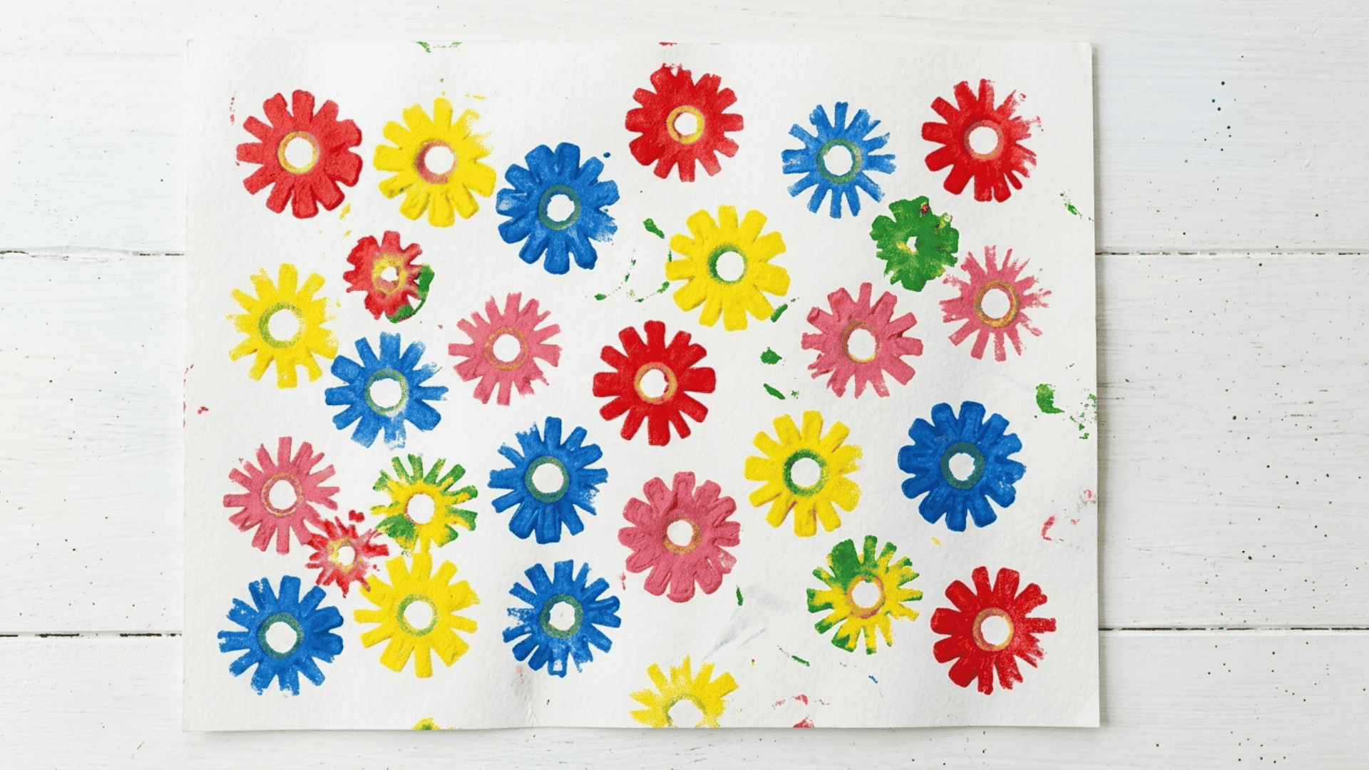 pool noodle flower stamp art with colorful paint prints on white background showing repeated flower patterns