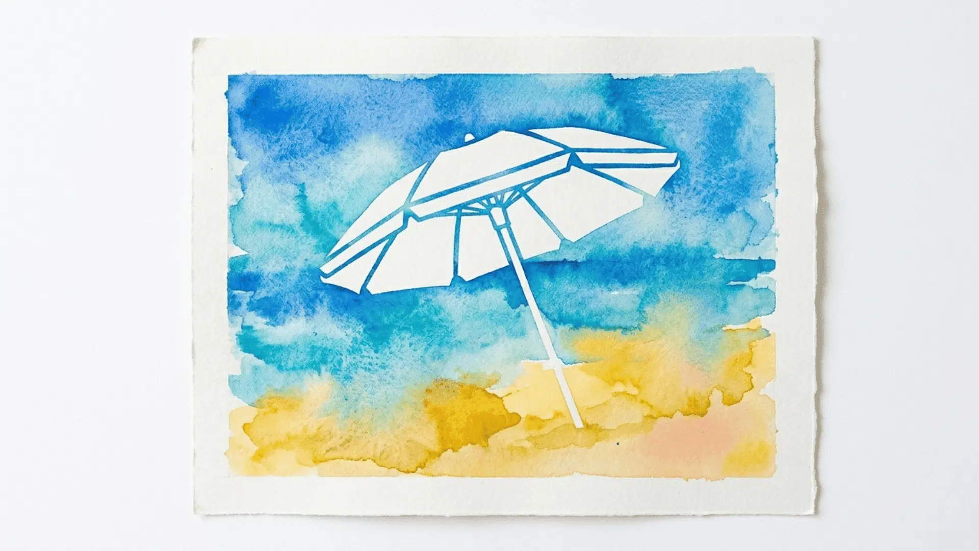 sticker resist beach umbrella art showing a clean umbrella shape revealed against a blue and yellow painted background on paper