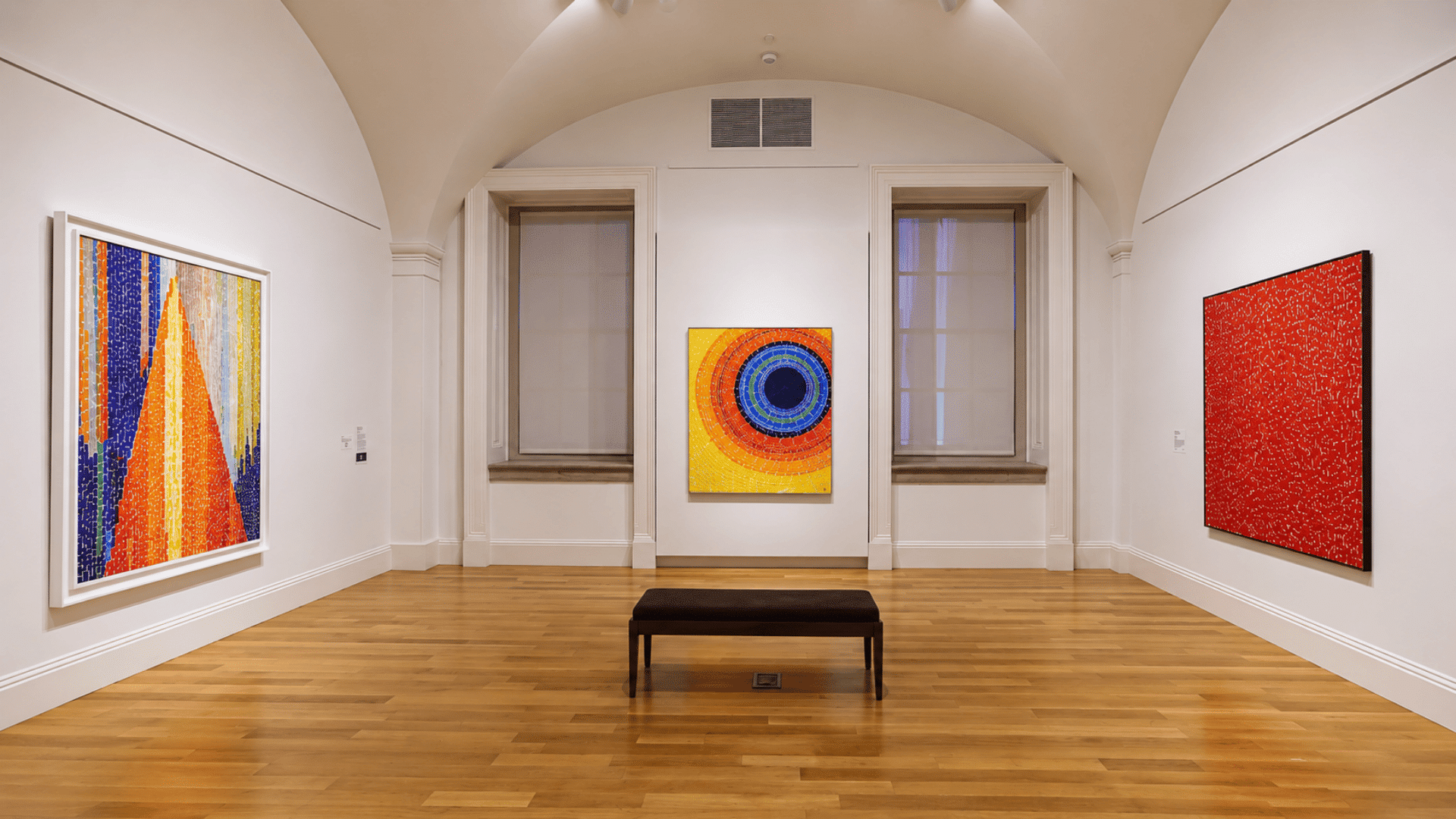 Smithsonian American Art Museum gallery featuring vibrant abstract paintings by Alma Thomas displayed in a bright hall.