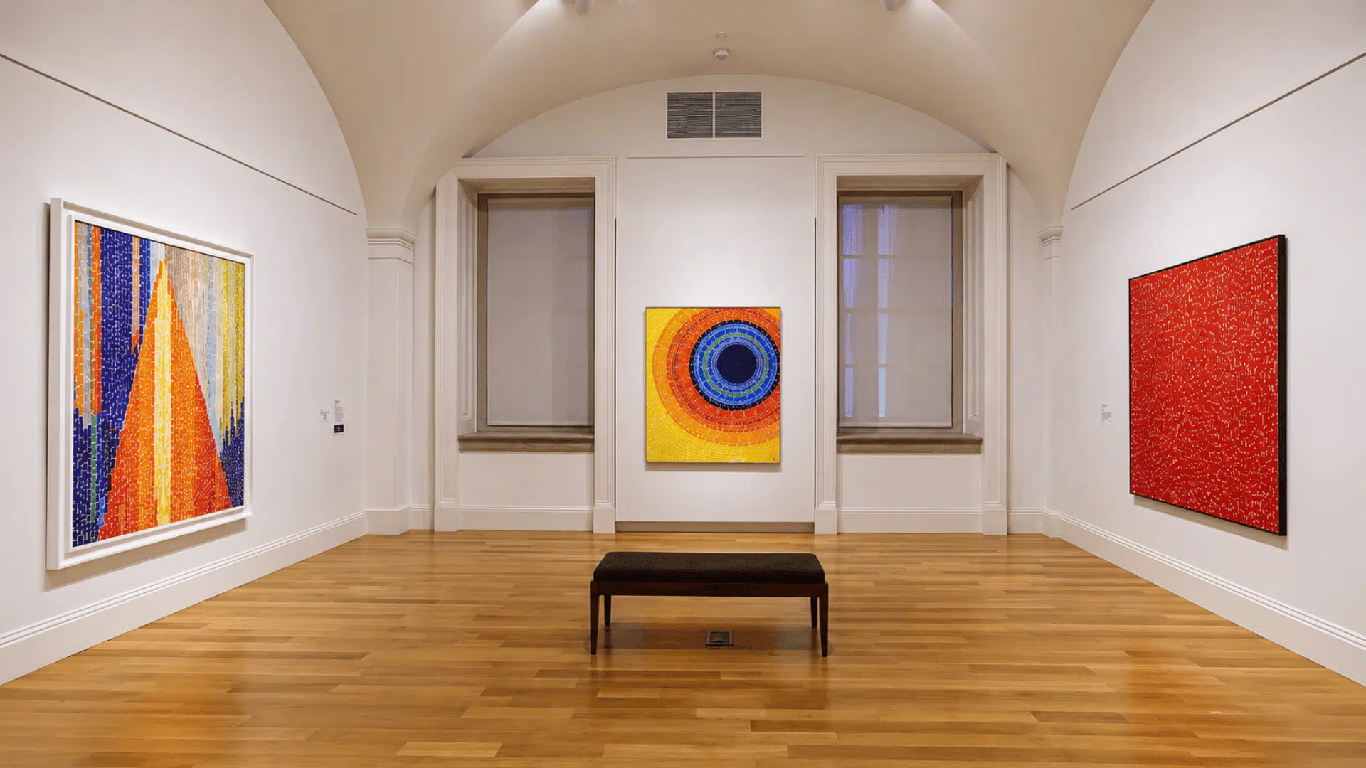 Smithsonian American Art Museum gallery featuring vibrant abstract paintings by Alma Thomas displayed in a bright hall.