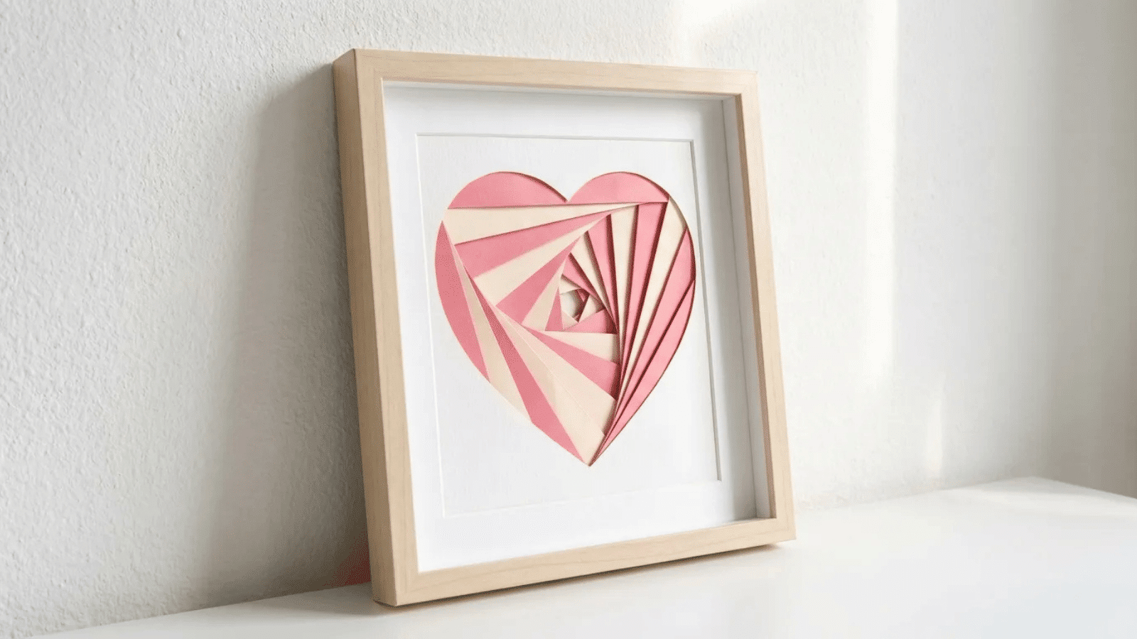 framed heart-shaped folded paper art in soft pink and cream tones, minimalist handmade wall decor for Mother’s Day gift