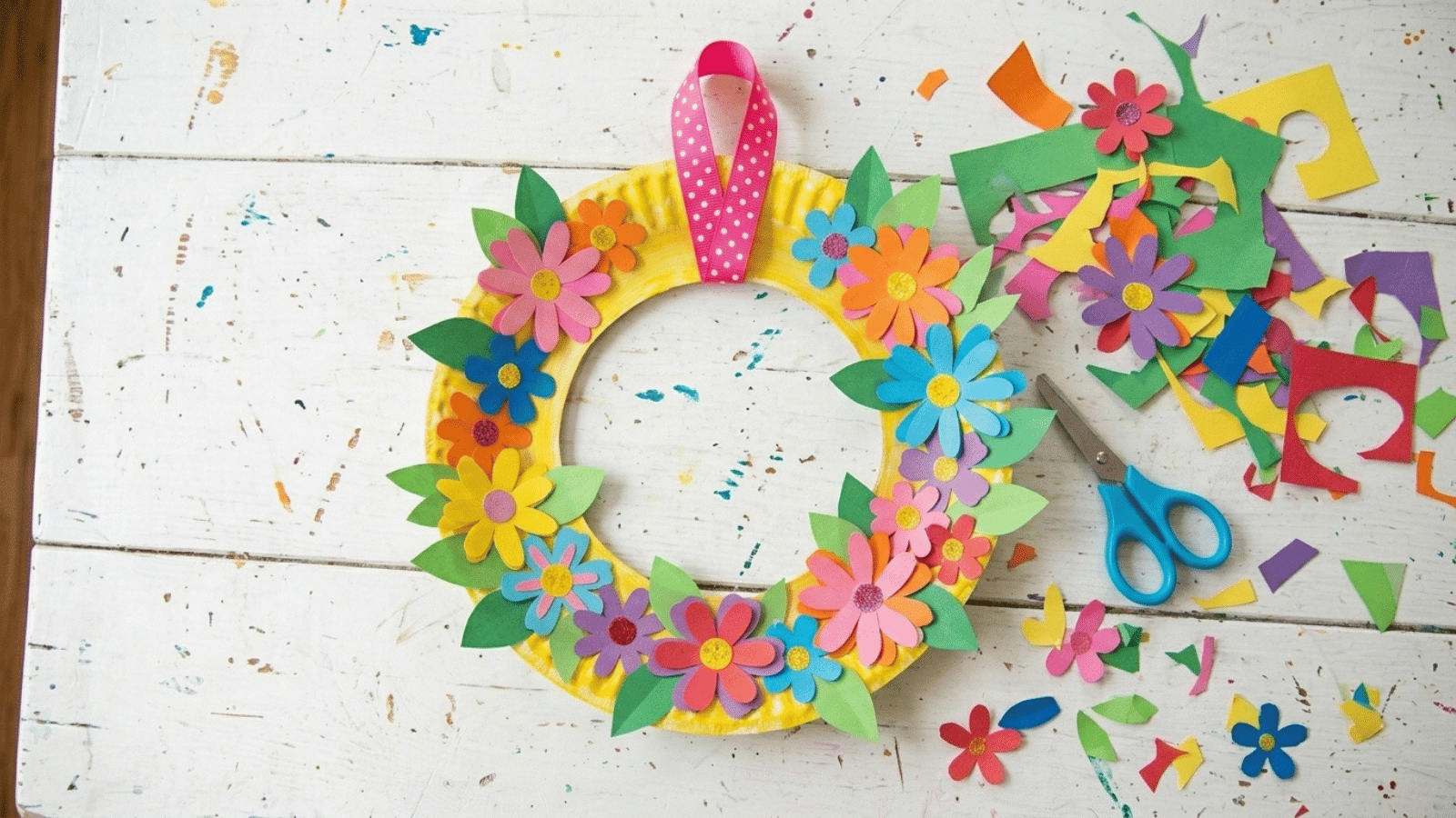 paper plate flower wreath craft with colorful cutouts, scissors, and supplies, ideal DIY decoration for Mother’s Day