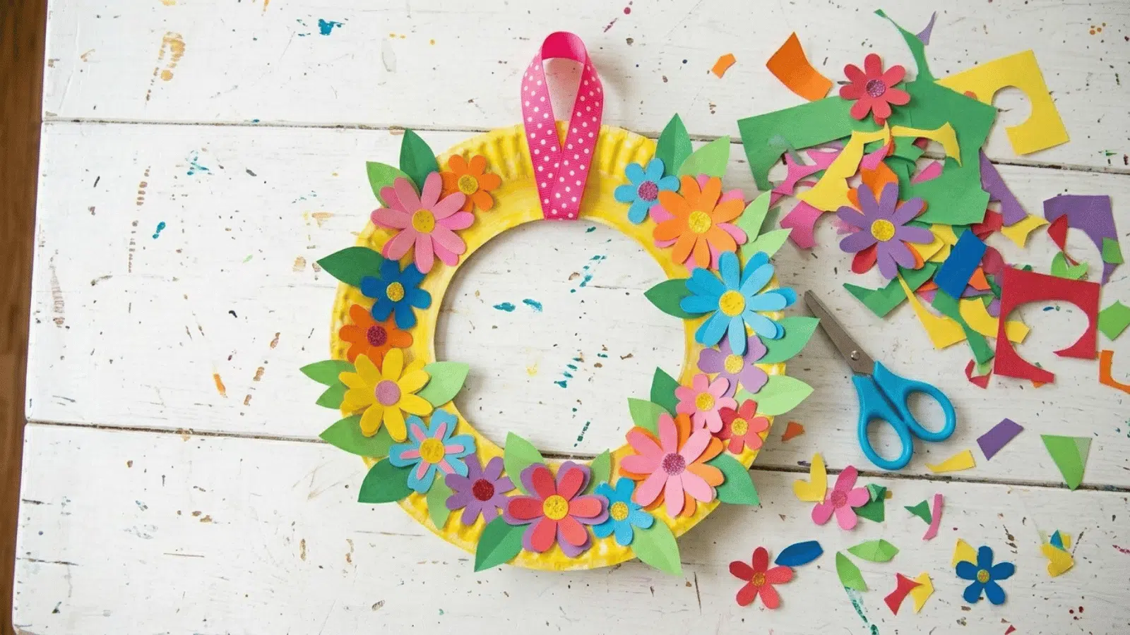 paper plate flower wreath craft with colorful cutouts, scissors, and supplies, ideal DIY decoration for Mother’s Day