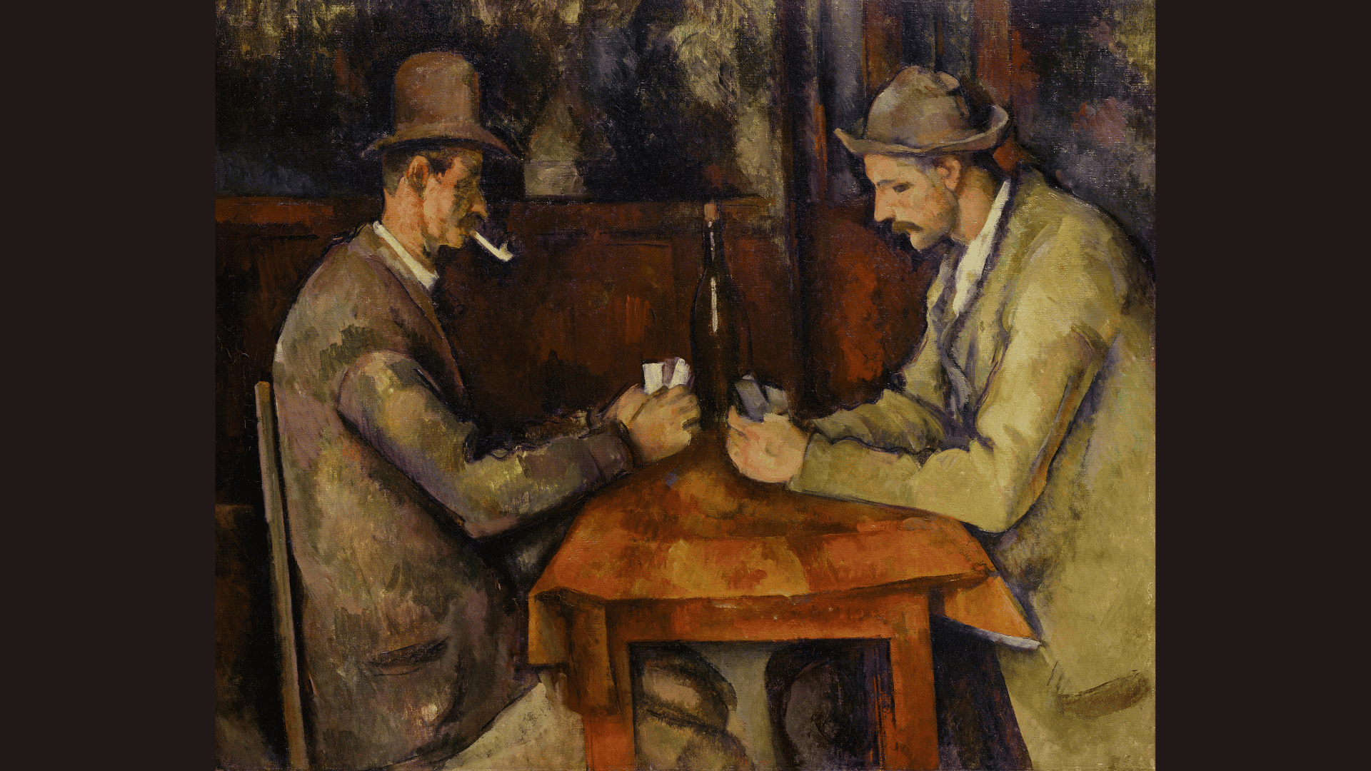 paul Cézanne artwork showing two men quietly playing cards at a wooden table indoors.