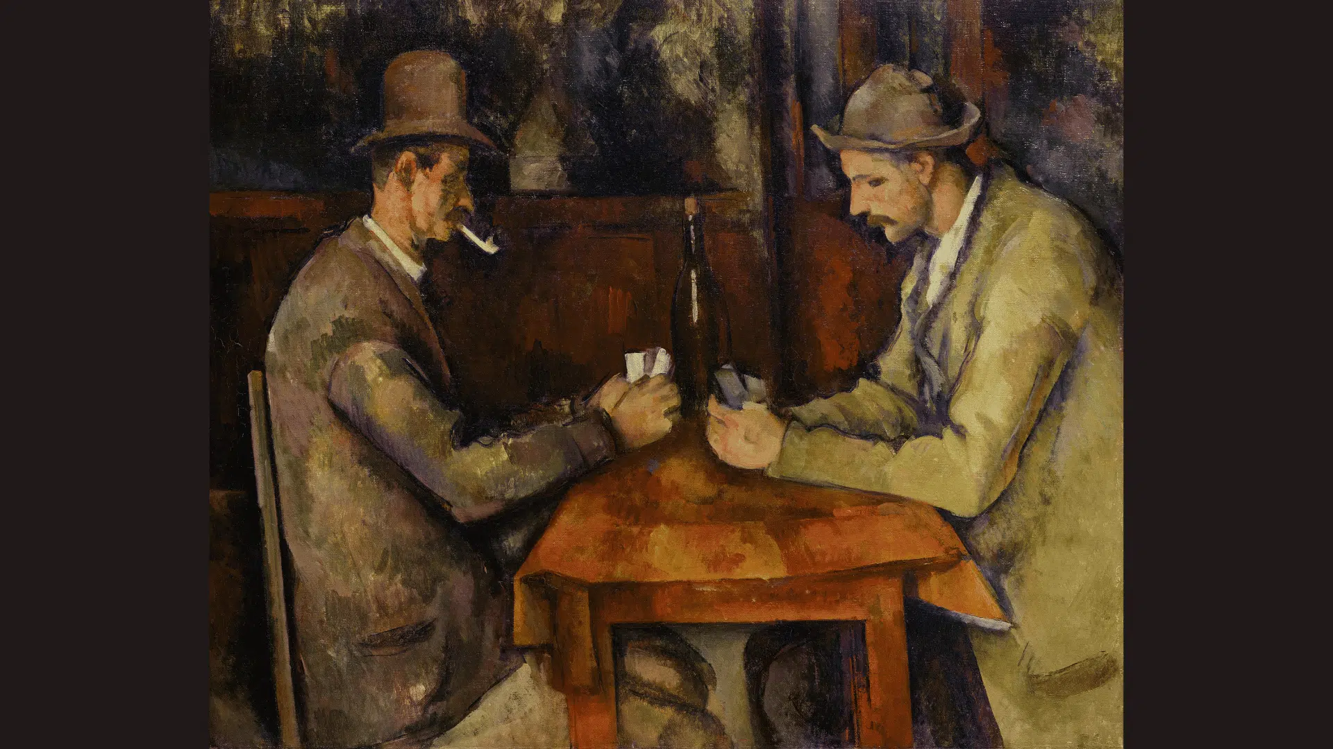 paul Cézanne artwork showing two men quietly playing cards at a wooden table indoors.