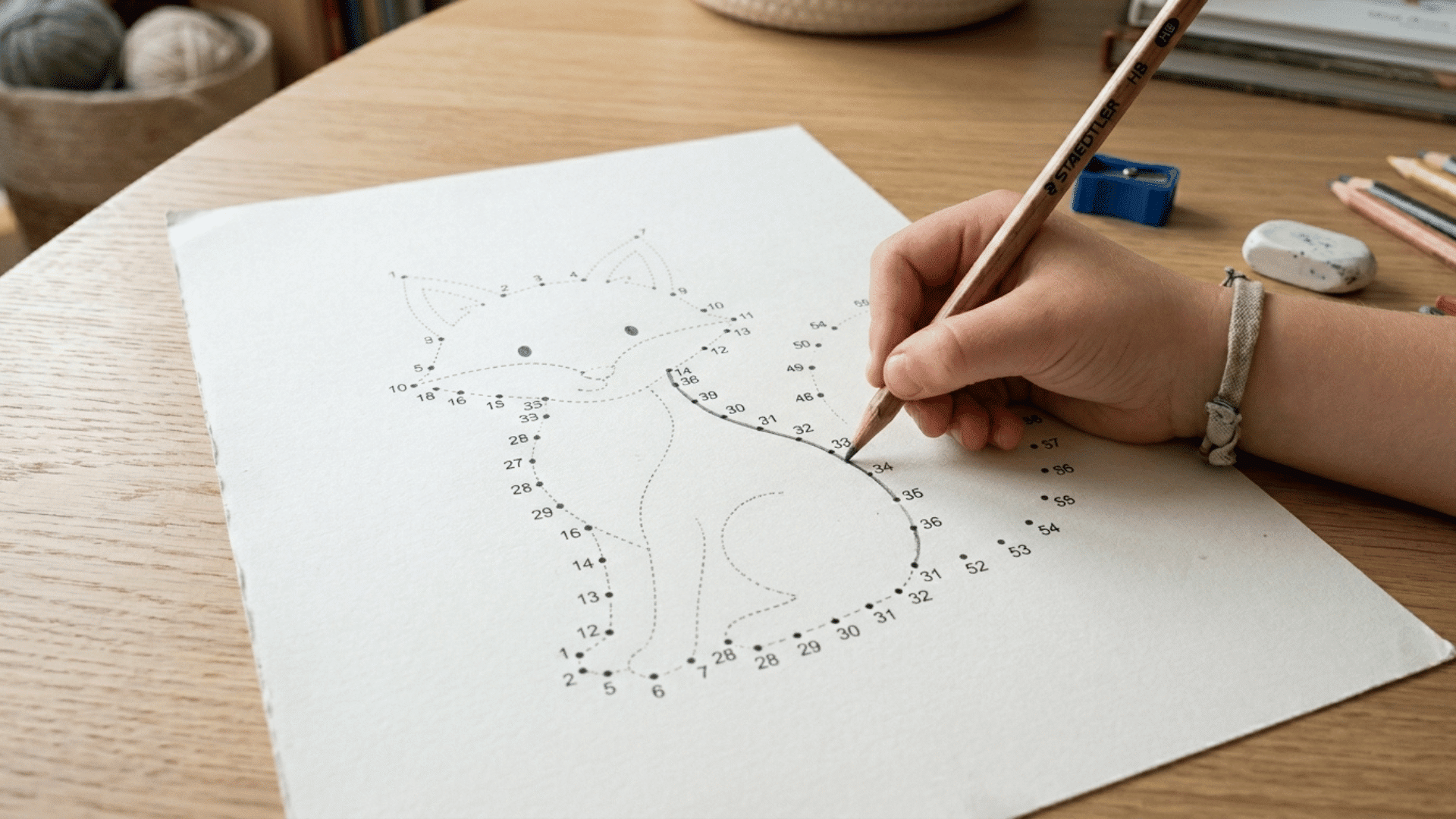 Sequentially numbered connect-the-dots puzzle forming an animal drawing with a pencil tracing the lines.