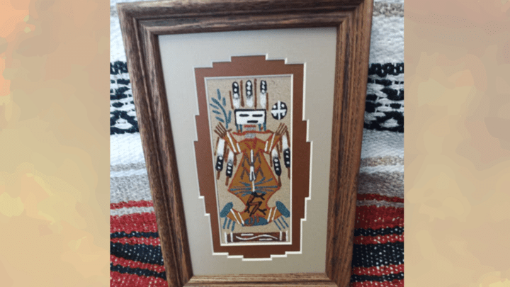 traditional navajo sand painting with framed tribal figure and southwestern native american handcrafted artwork