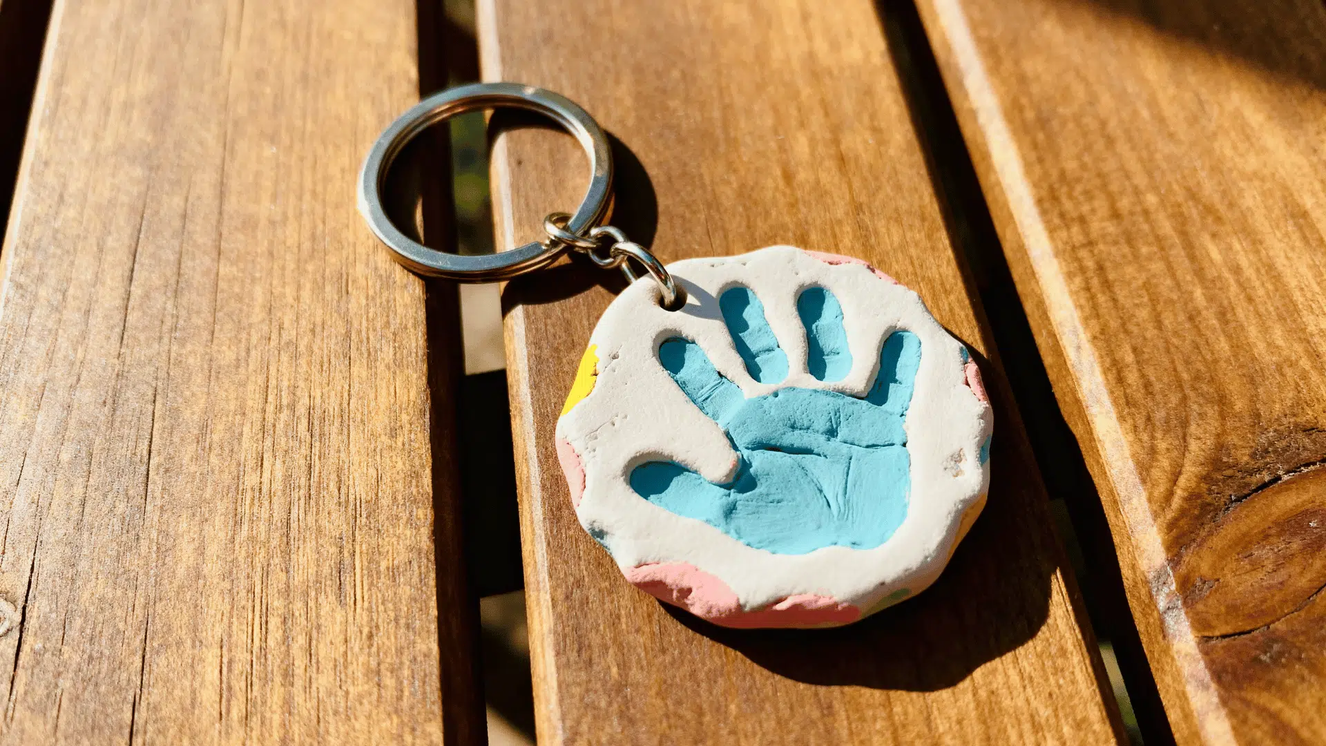 small clay handprint keychain handmade by a toddler for Father’s Day.