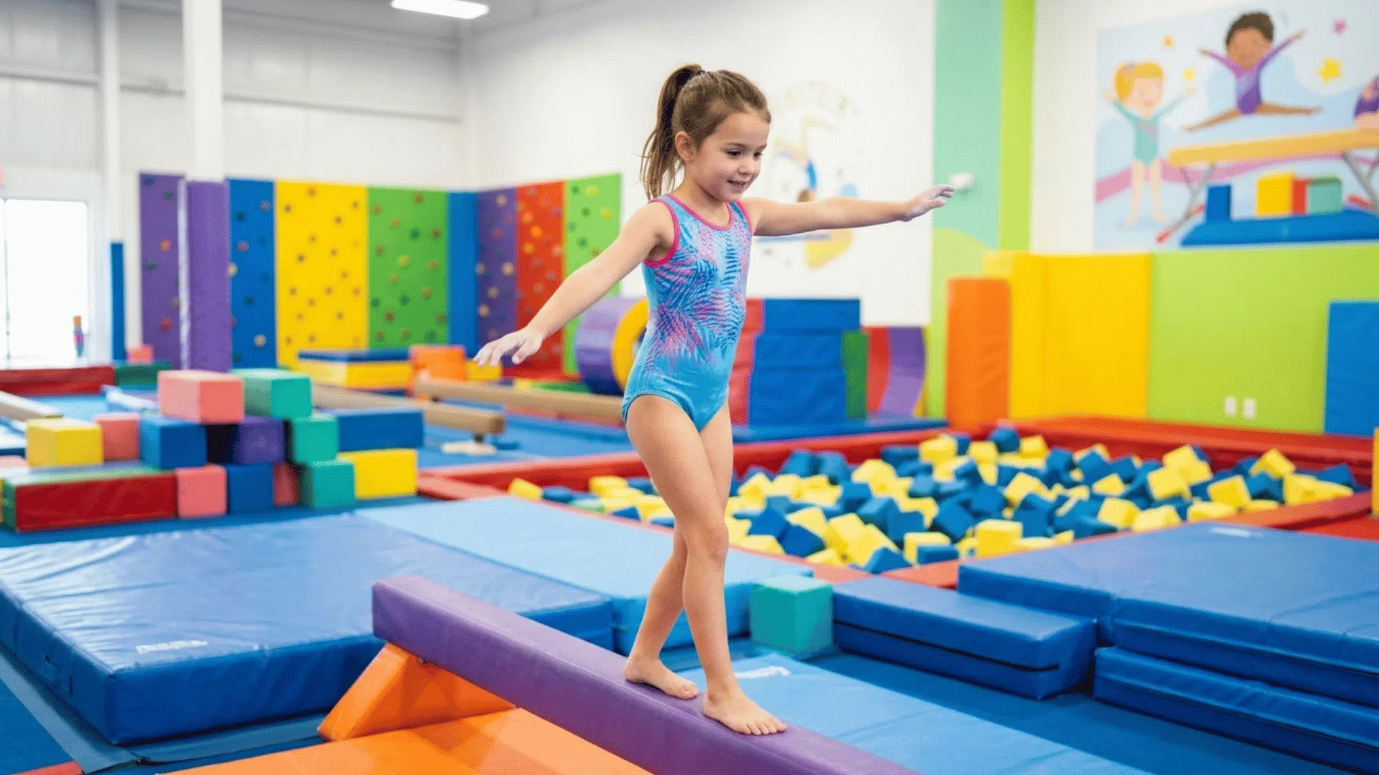 young gymnast balances carefully on a beam in a colorful indoor gymnastics facility.