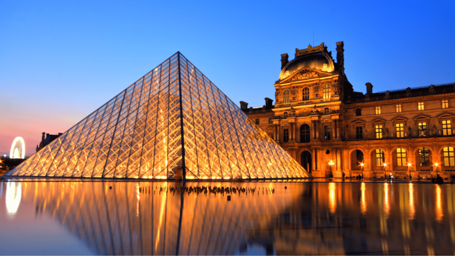 louvre museum exterior in paris with glass pyramid and visitors near the entrance