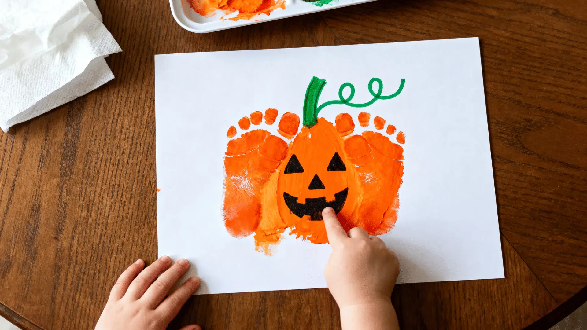 cute pumpkin footprint art created with a toddler's painted footprint on cardstock
