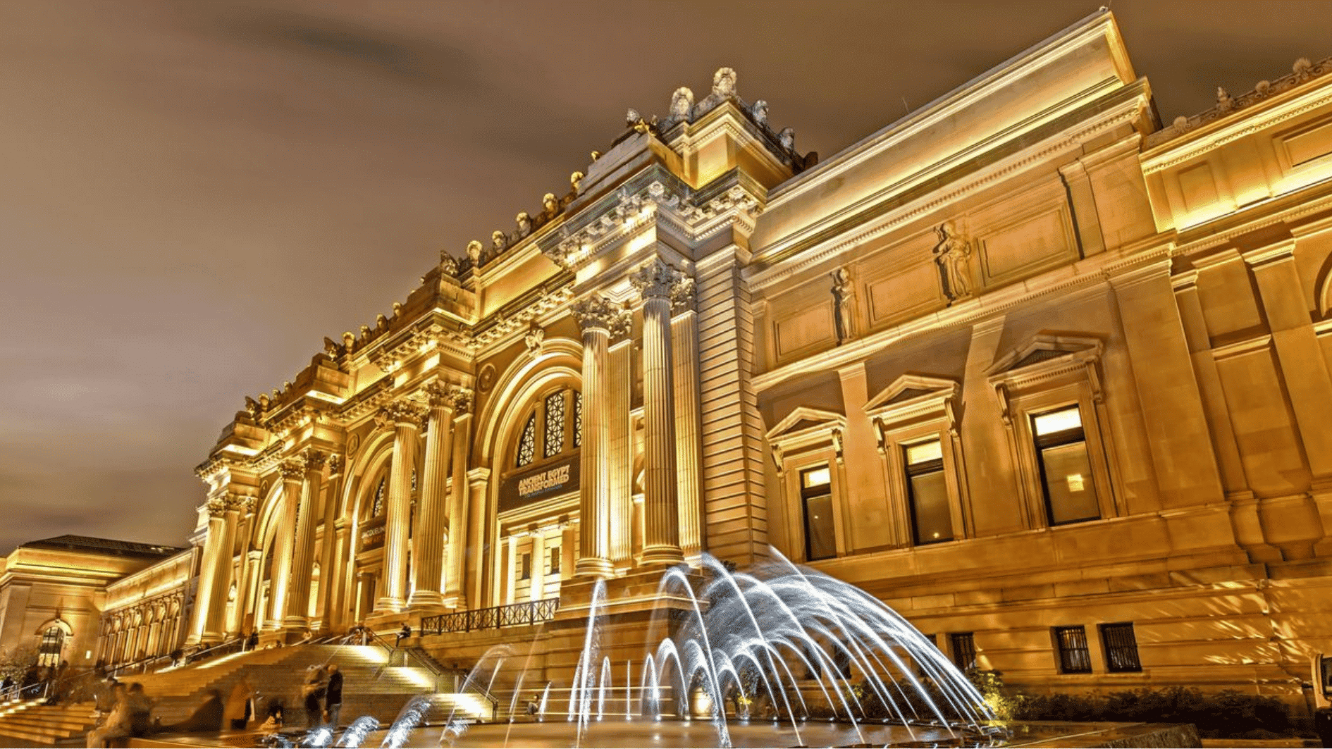 the metropolitan museum of art in new york city with grand steps and museum facade