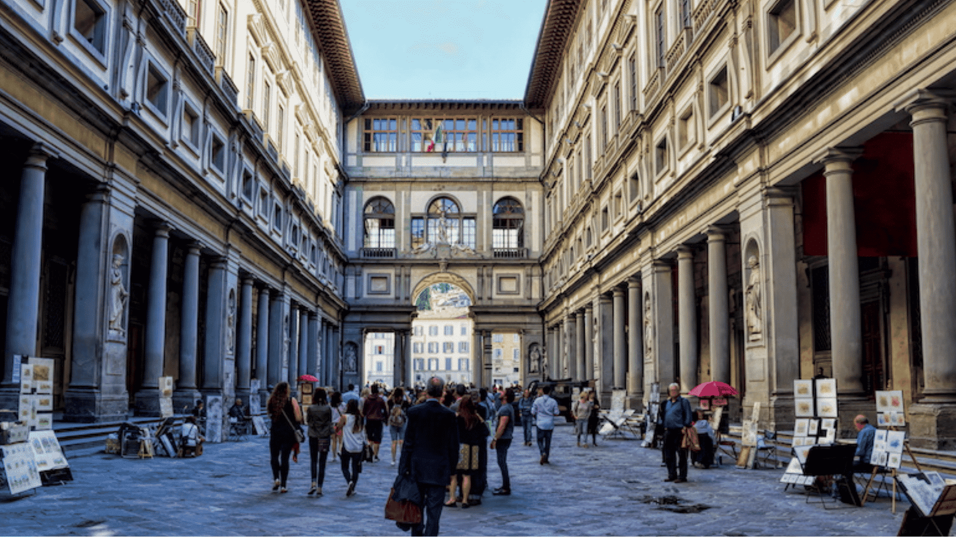 uffizi galleries in florence with renaissance museum courtyard and visitors walking