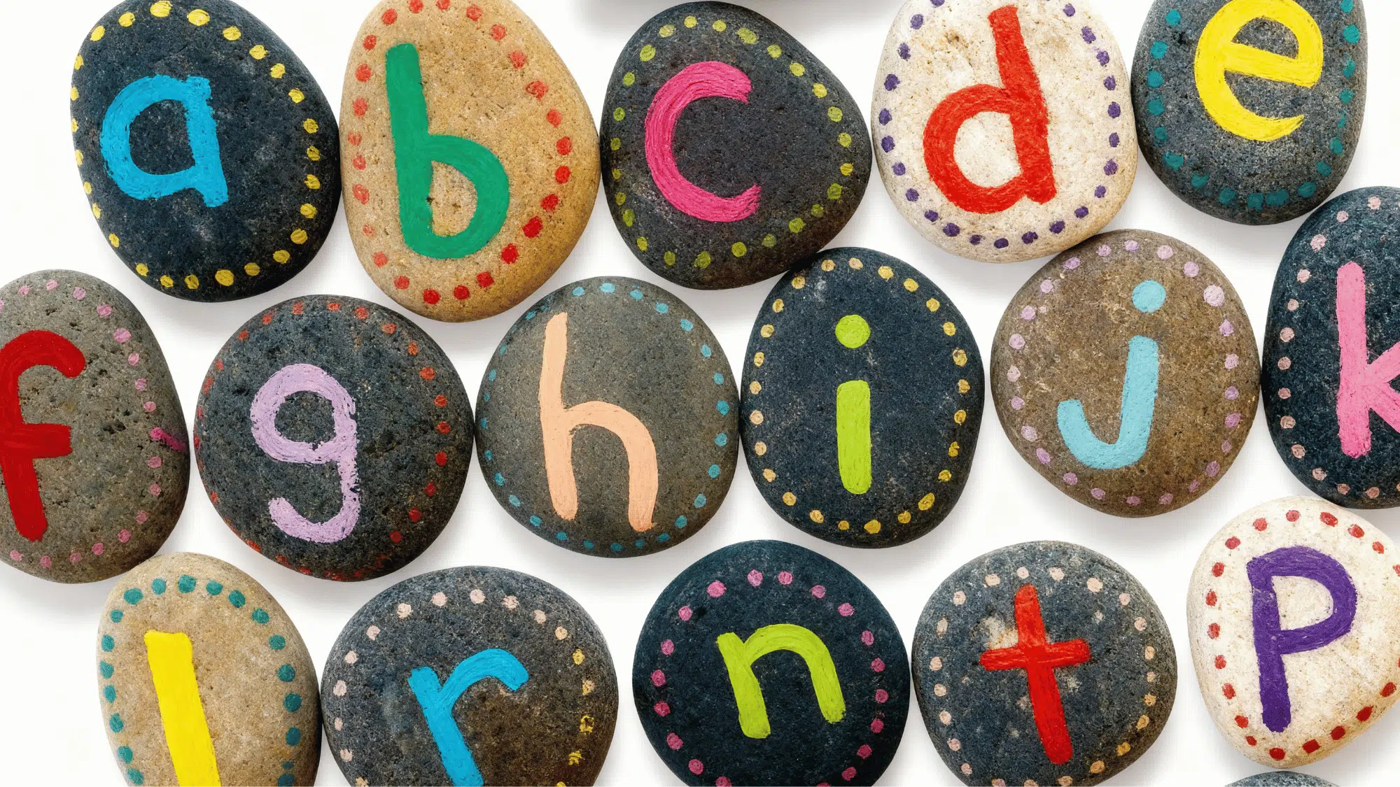 Colorful alphabet letters painted on smooth rocks with dotted borders
