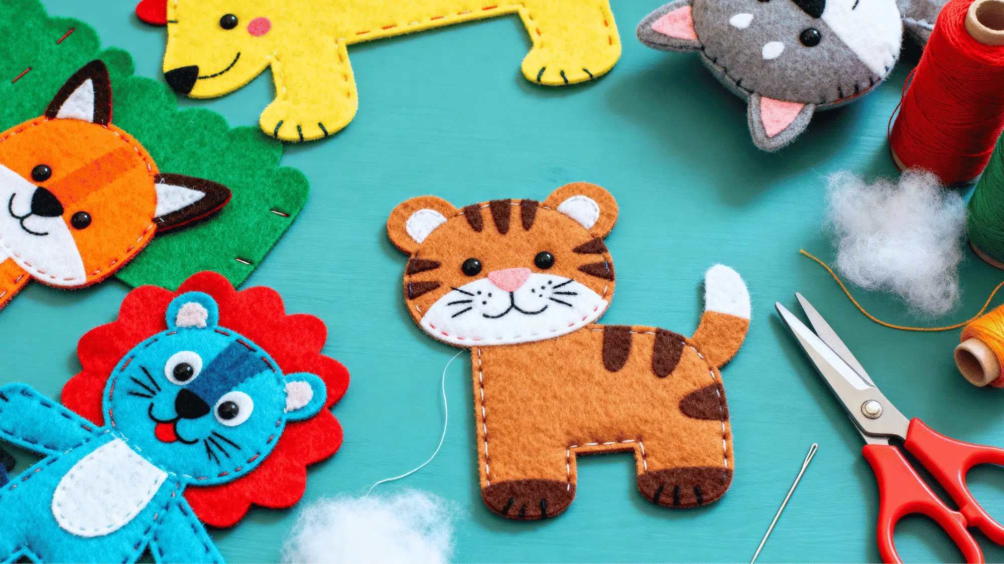 Felt puppets and soft toys made from colorful felt, stitched edges, and cotton stuffing on a craft table.