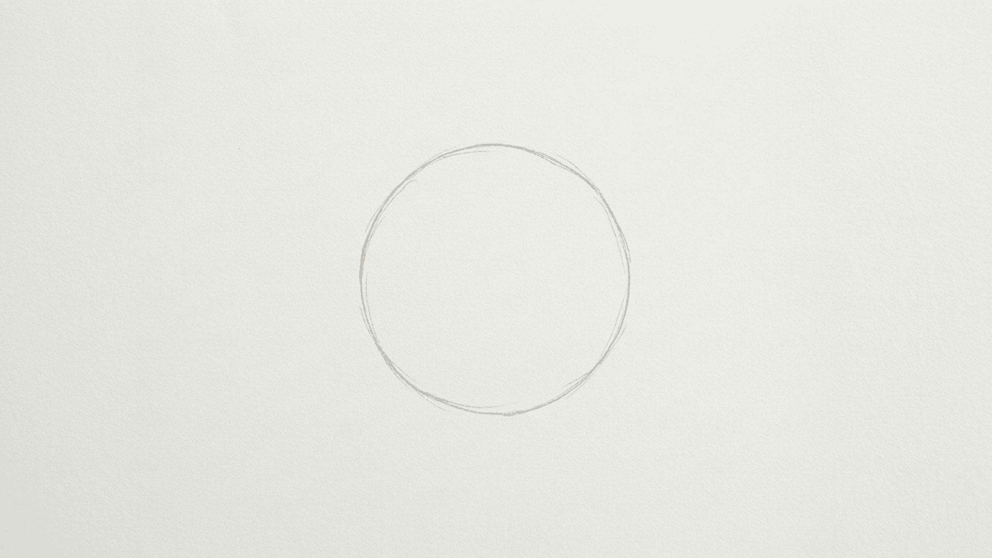 light pencil circle drawn on white paper as the starting shape for a sunflower drawing