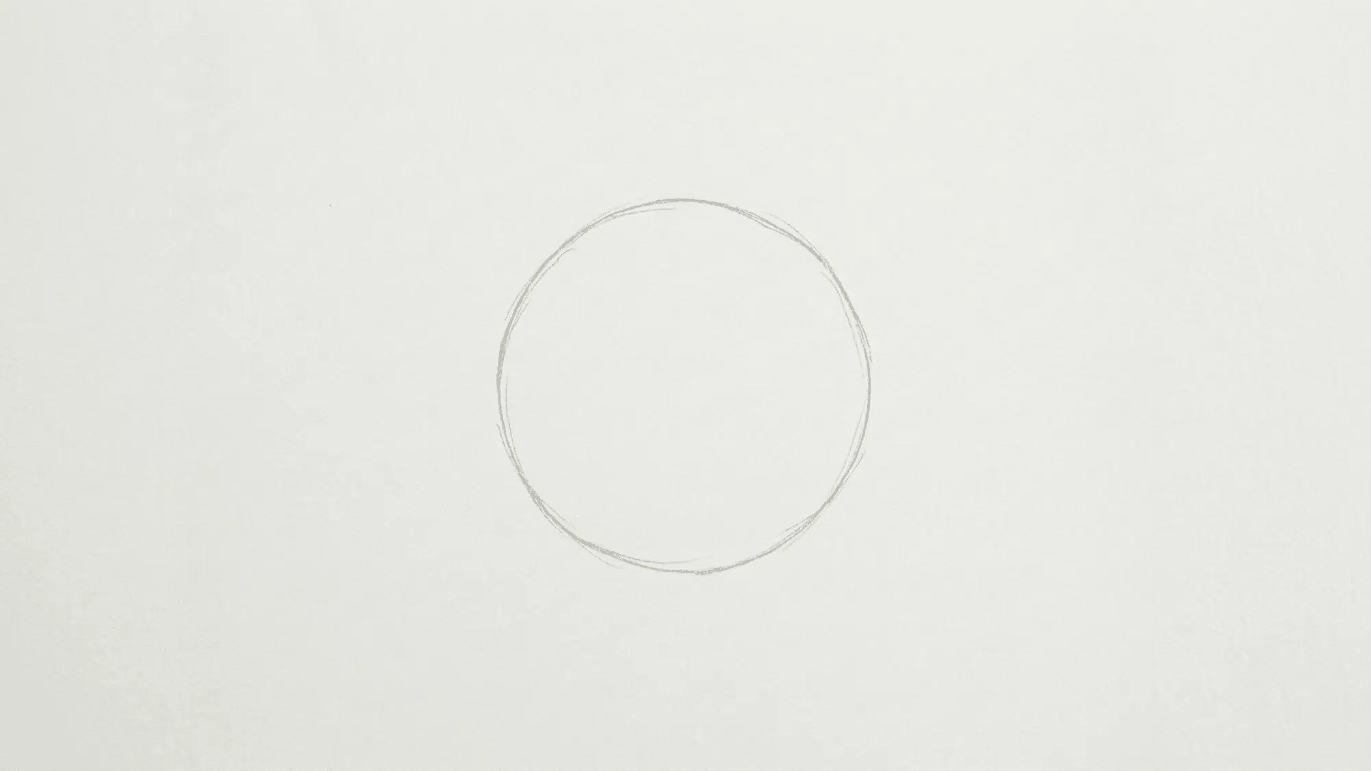 light pencil circle drawn on white paper as the starting shape for a sunflower drawing