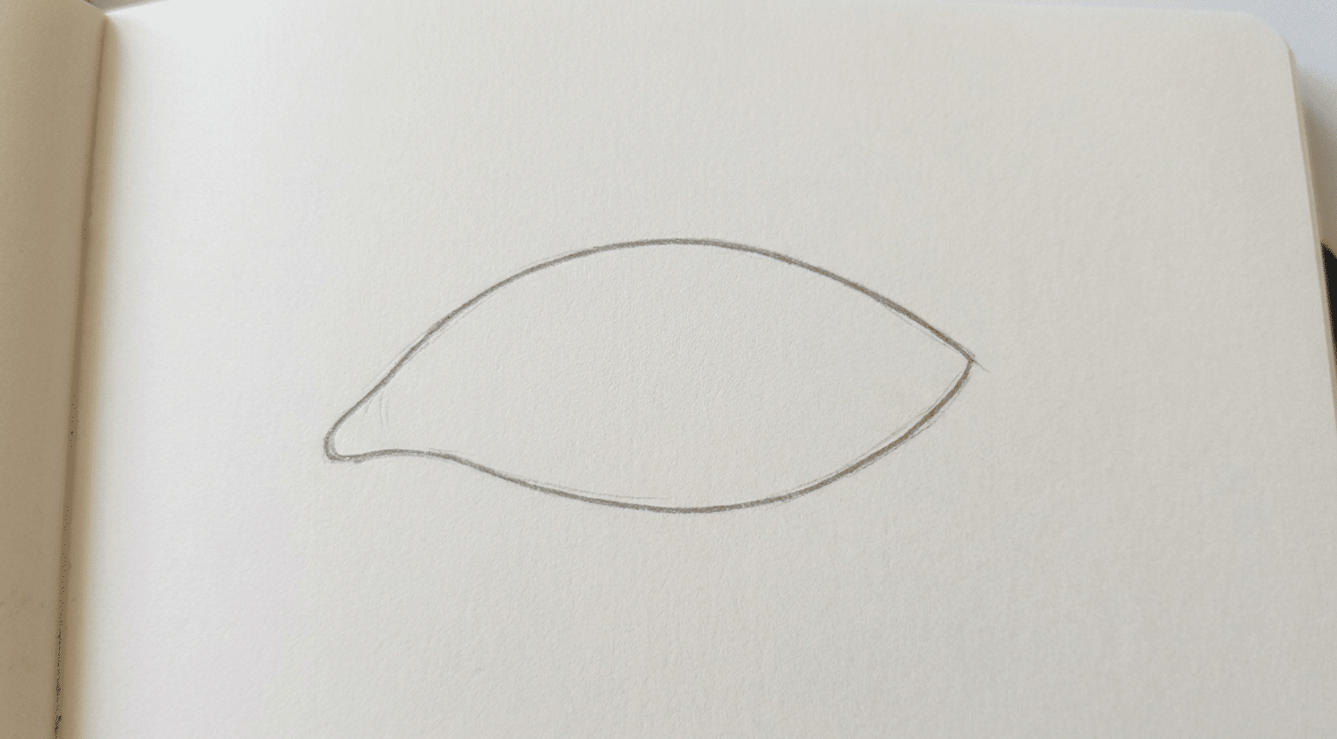 simple almond-shaped eye outline serving as the first step in drawing a realistic eye.