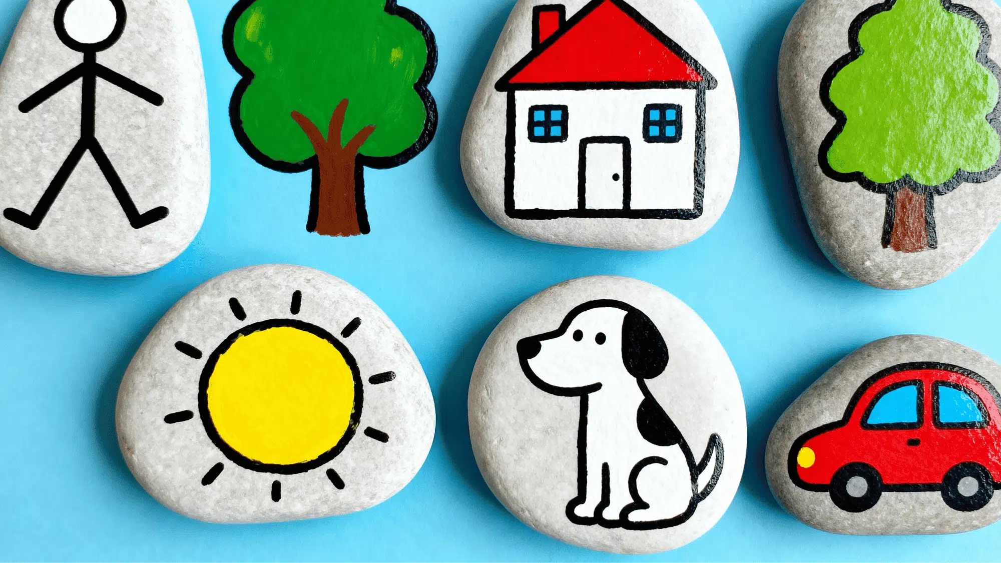 Set of story stones with person house tree sun dog and car