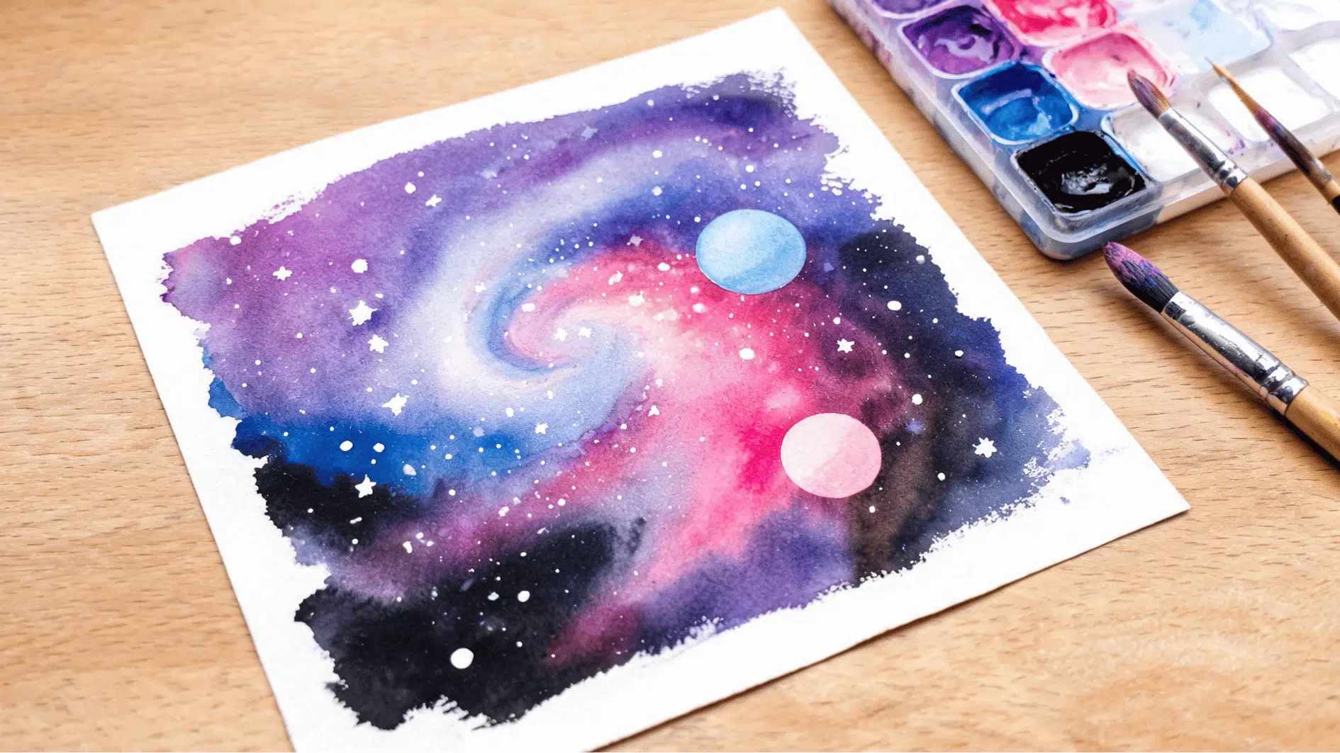 watercolor galaxy painting with swirling nebula colors planets and scattered stars on white paper