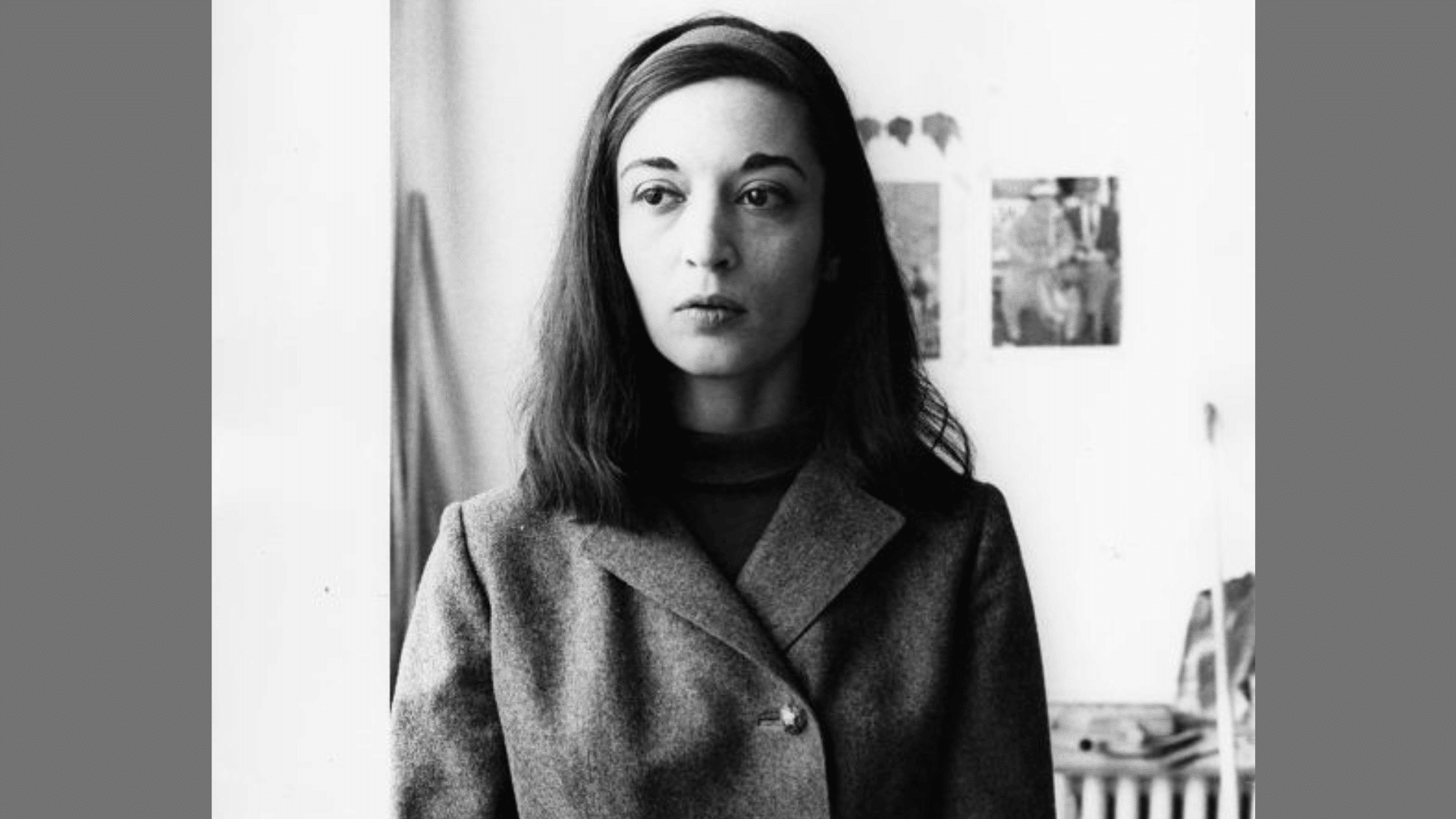 a black-and-white vintage portrait of a woman with a headband wearing a tailored buttoned coat