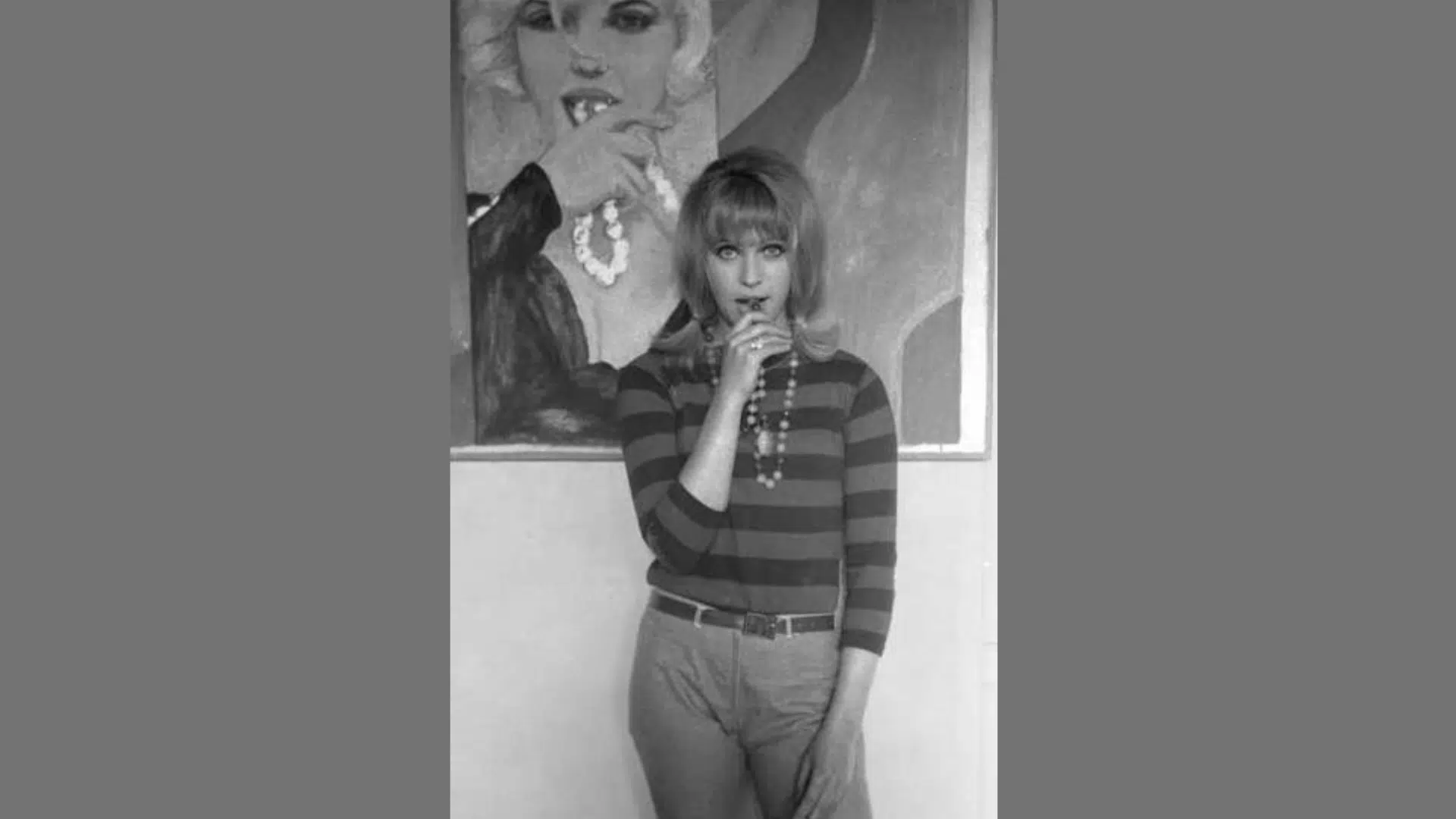 a black-and-white vintage portrait of a young woman with bangs and a classic bouffant hairstyle