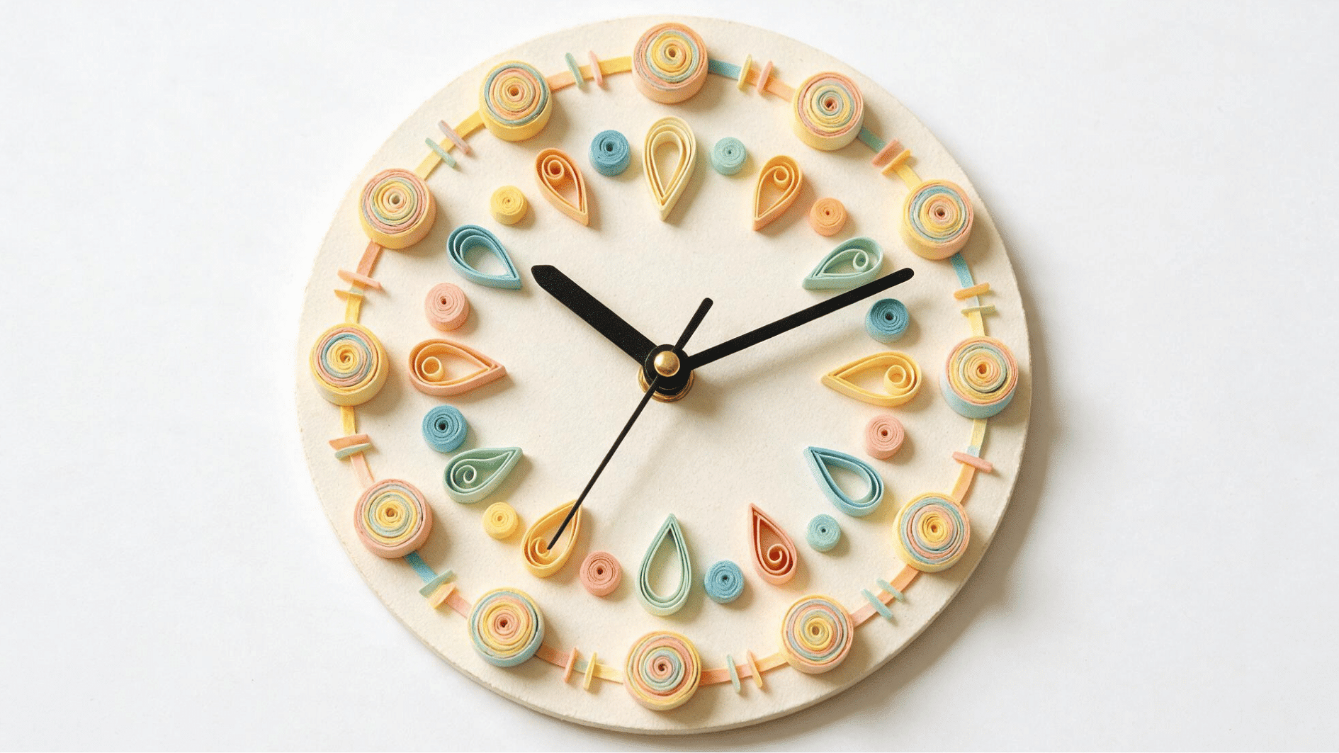 quilled paper wall clock decorated with pastel spirals and teardrop shapes with black clock hands