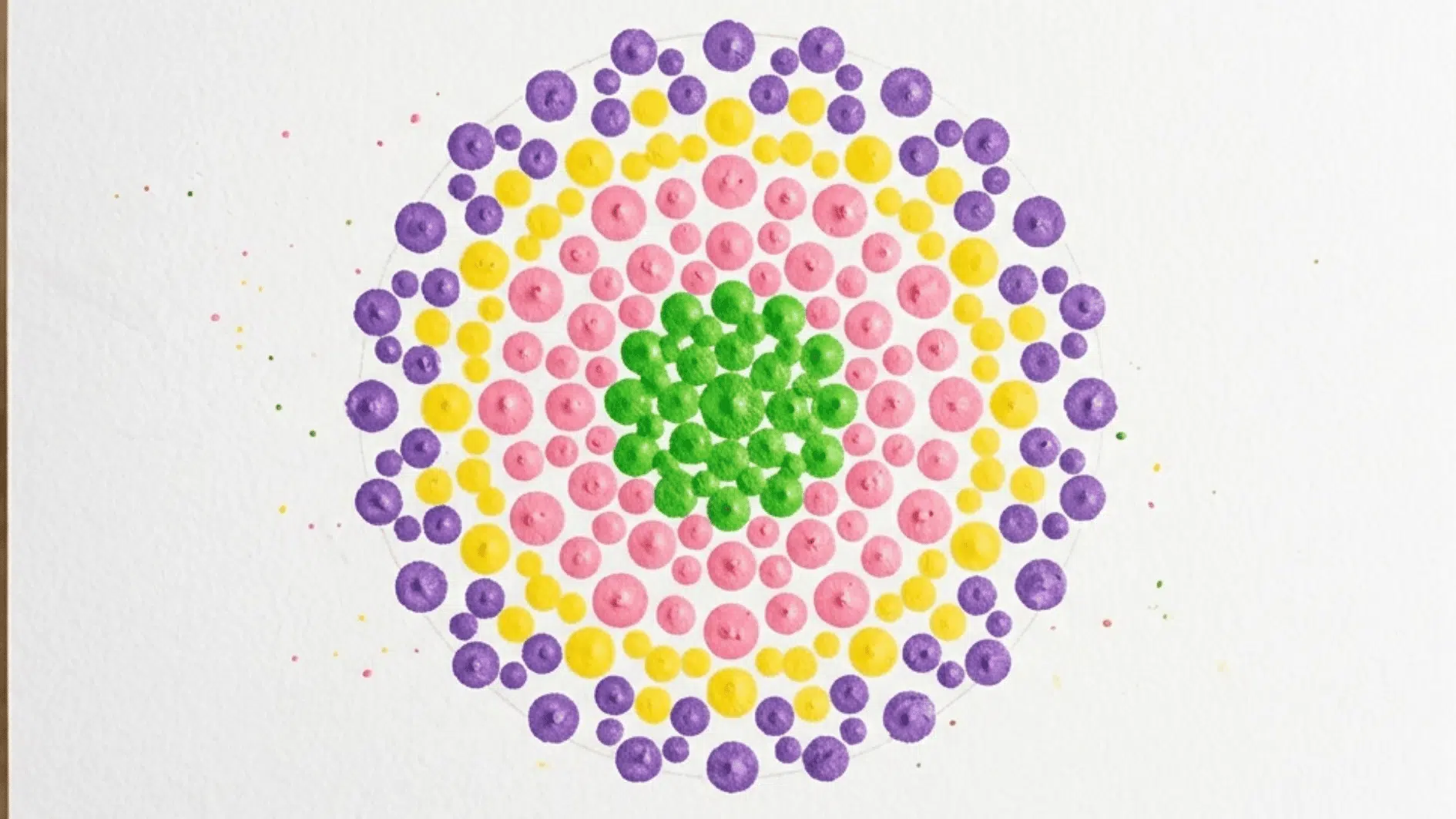 cotton swab dot art flower in green pink yellow and purple on white paper
