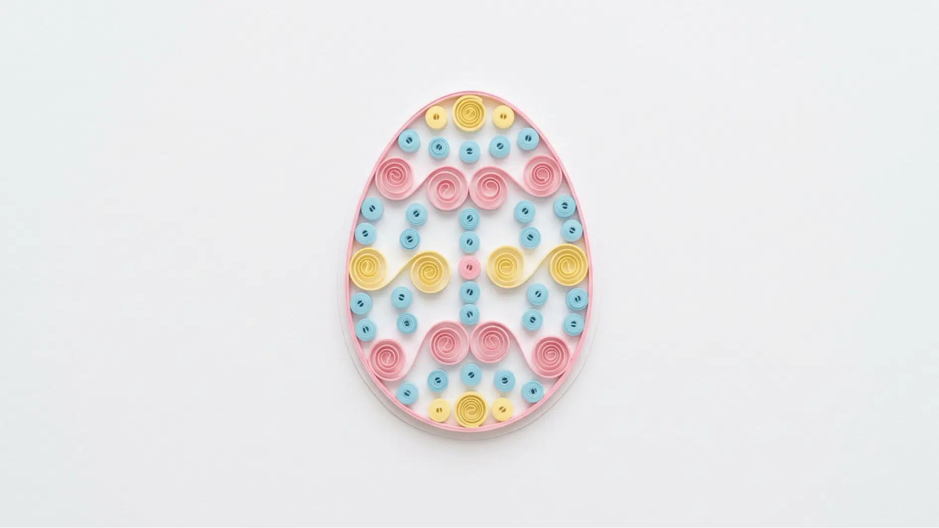 quilled paper easter egg decorated with pink blue and yellow spiral patterns on white background