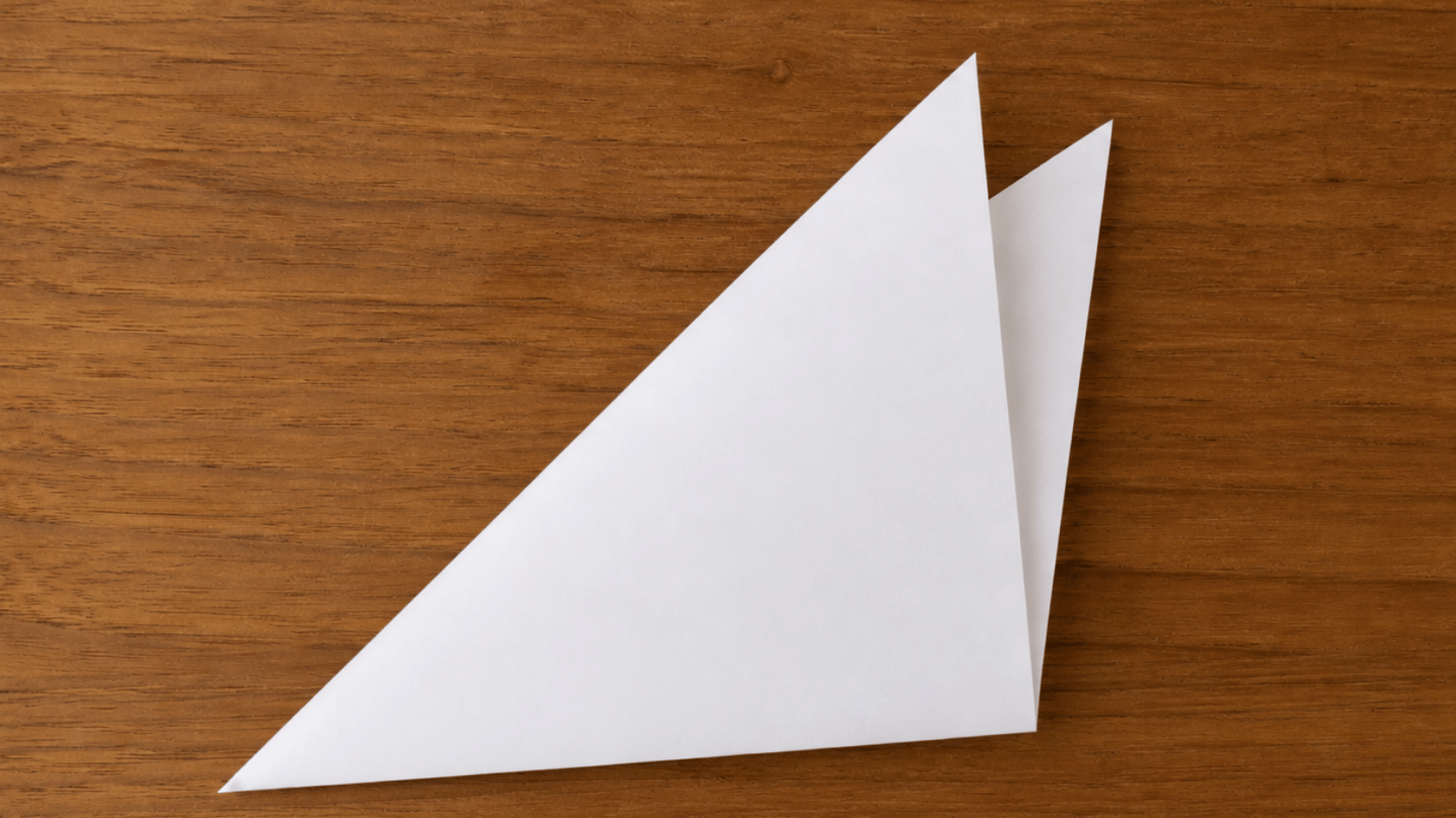 folded white paper triangle showing the paper folded into thirds