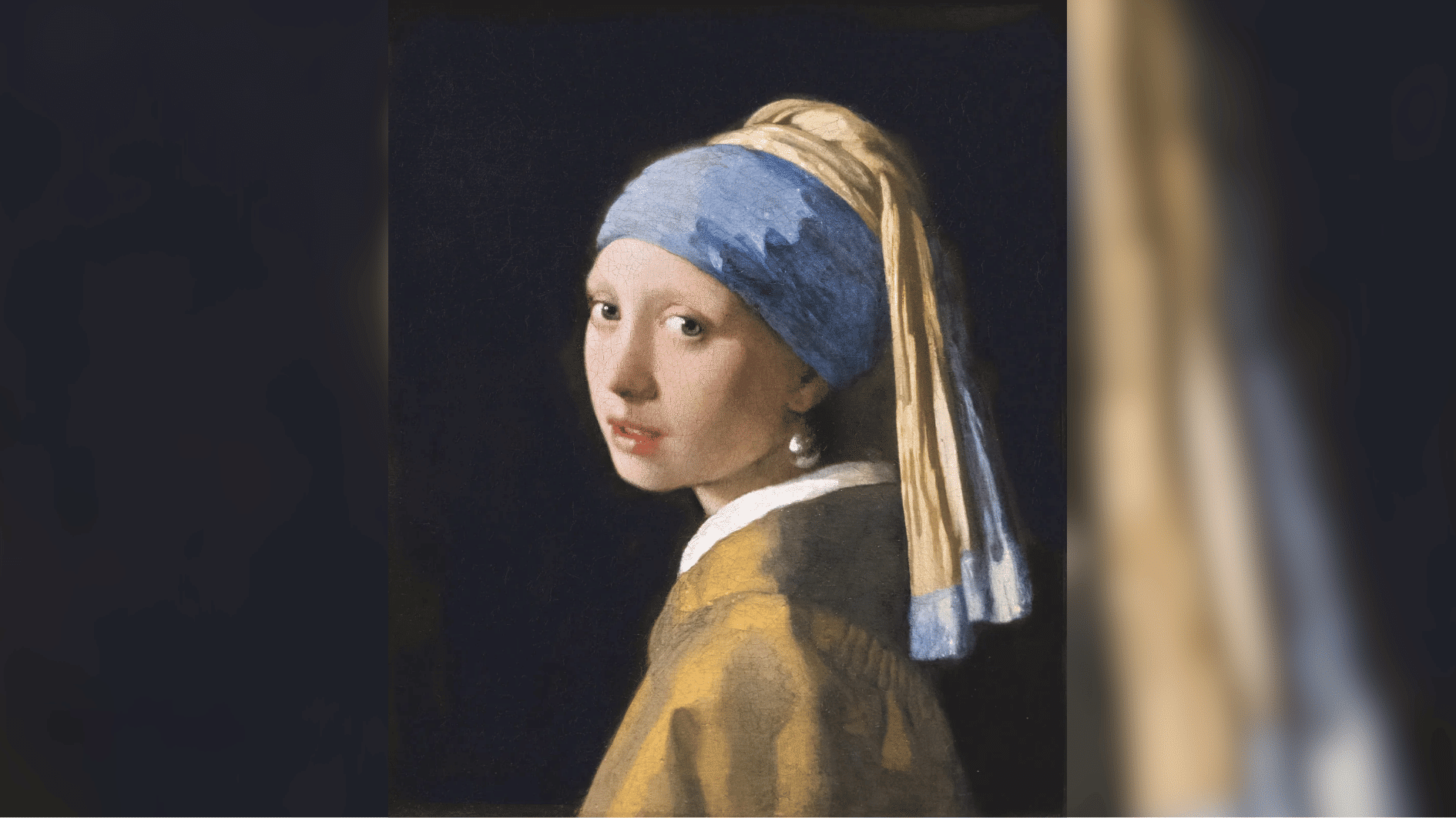 girl with a pearl earring looking over her shoulder against a dark background