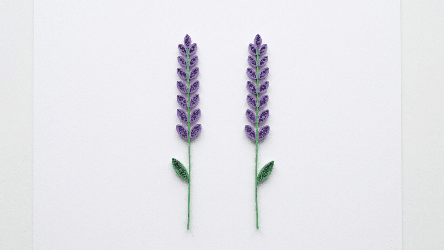 quilled paper lavender stems with purple buds and green leaves on white background