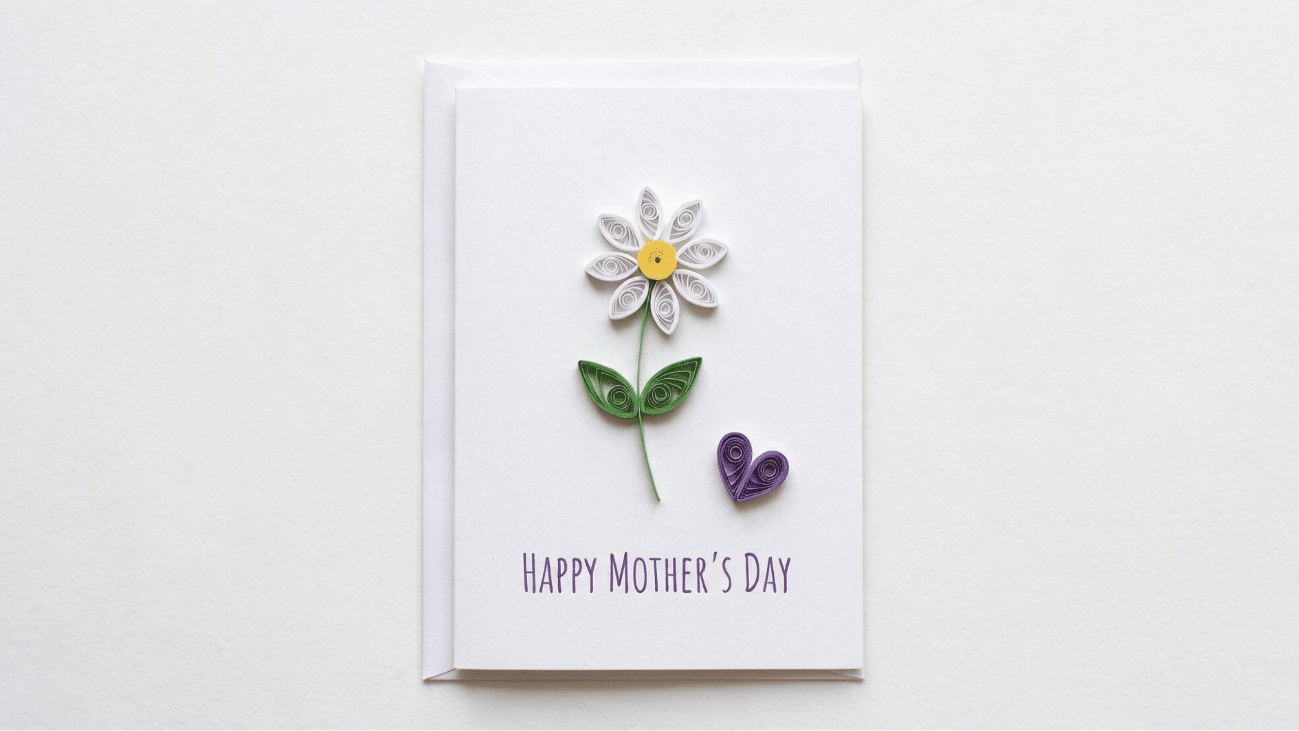 mothers day card with quilled paper white daisy green leaves and purple heart on white background