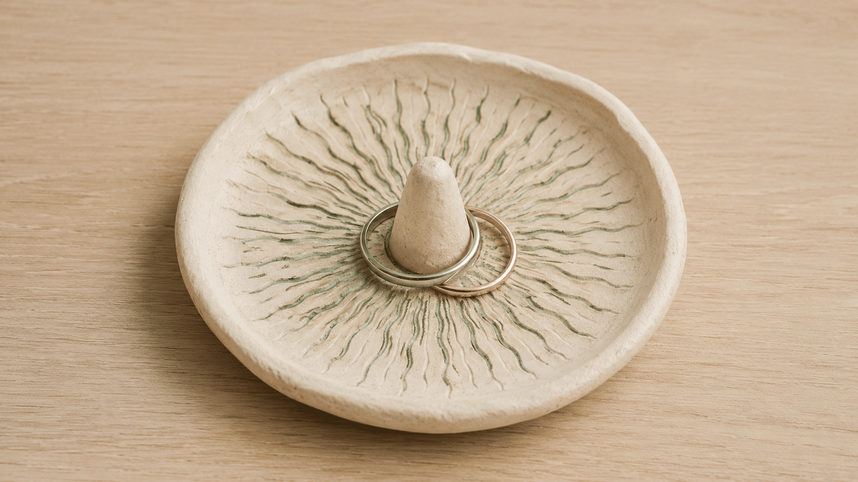 round clay ring dish decorated with pressed leaf patterns
