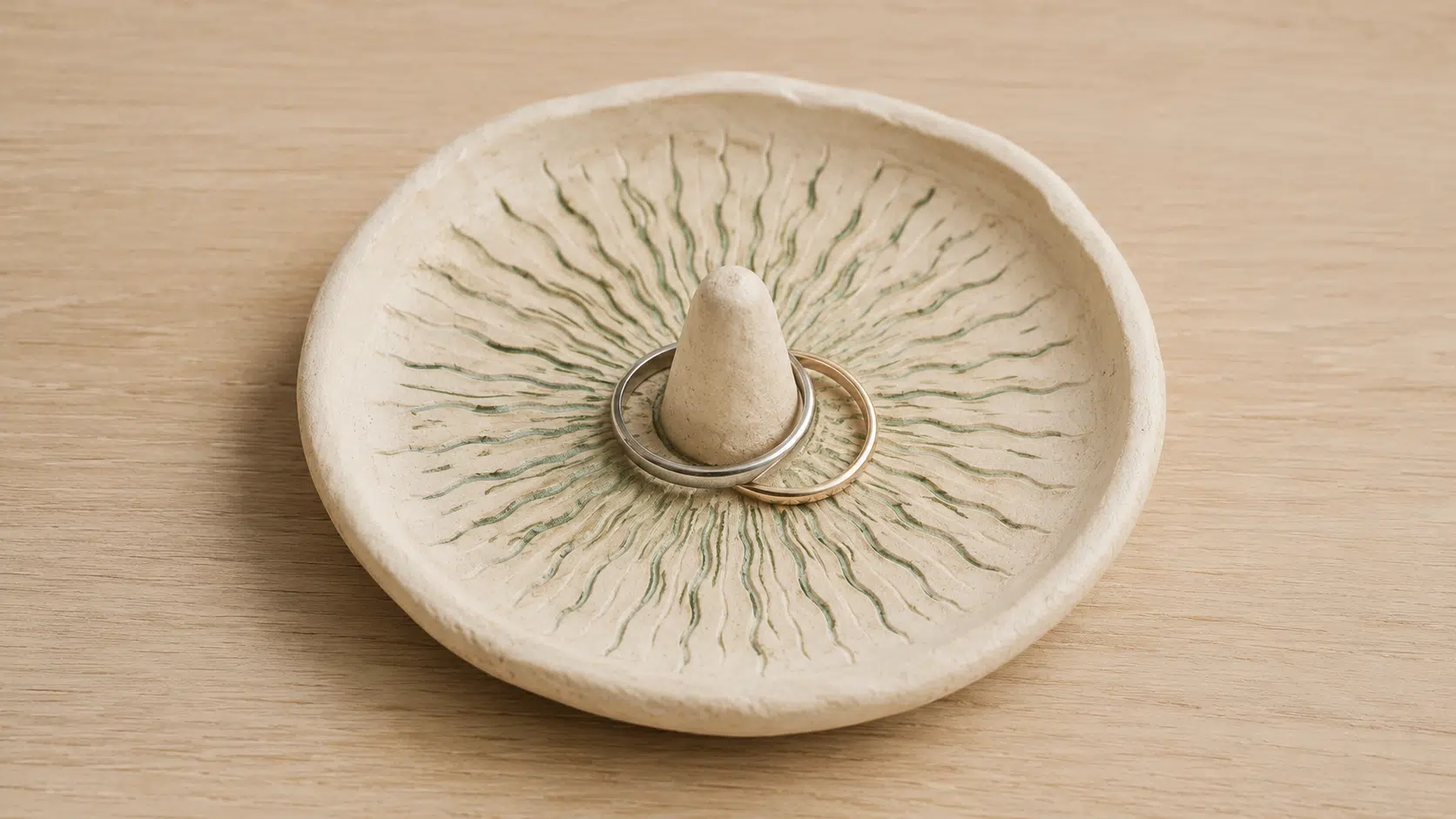 round clay ring dish decorated with pressed leaf patterns