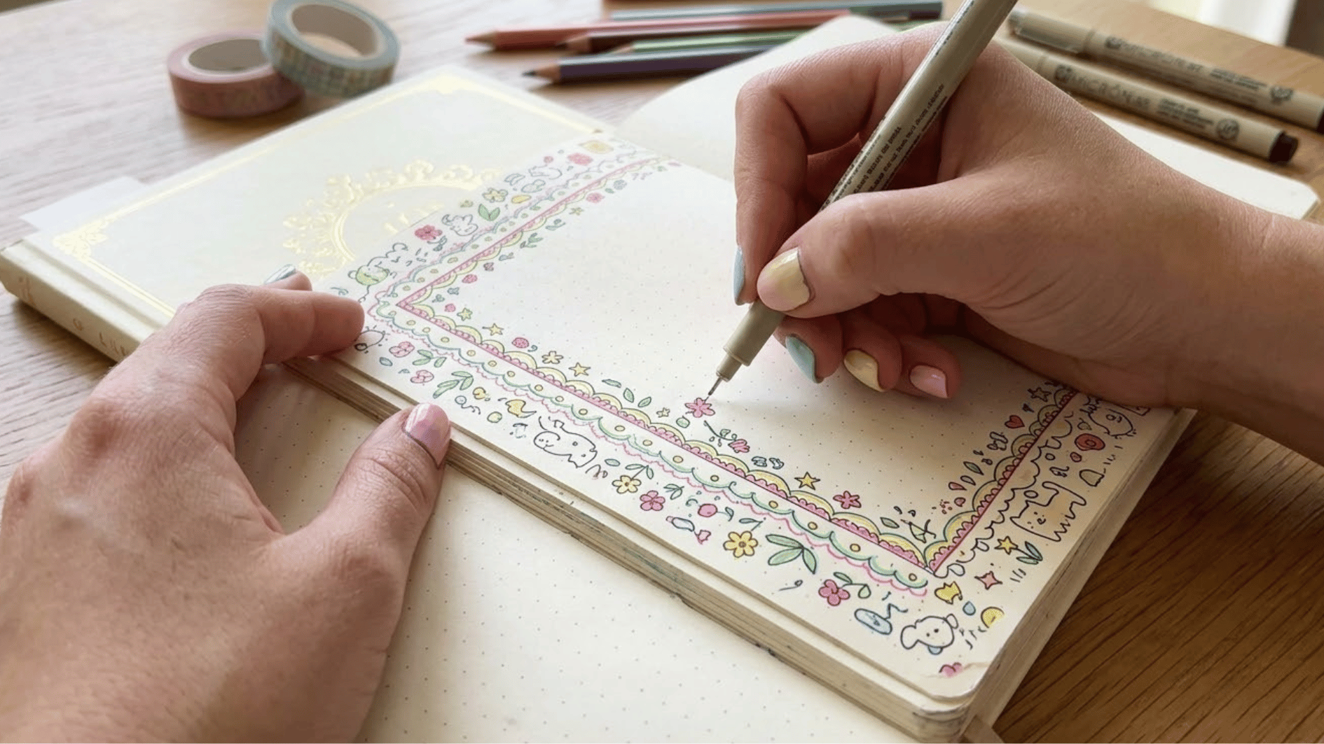 person making cute colorful flower and doodles borders on a journal page