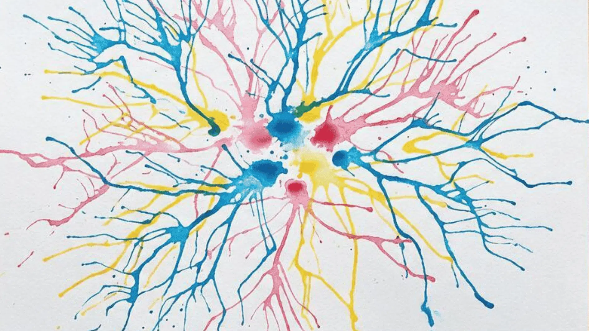 straw blown paint artwork with blue pink and yellow branching tree like patterns