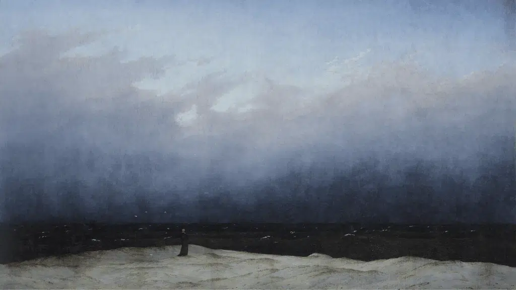 a solitary monk in black stands facing the endless horizon where dark sea meets a vast, brooding sky
