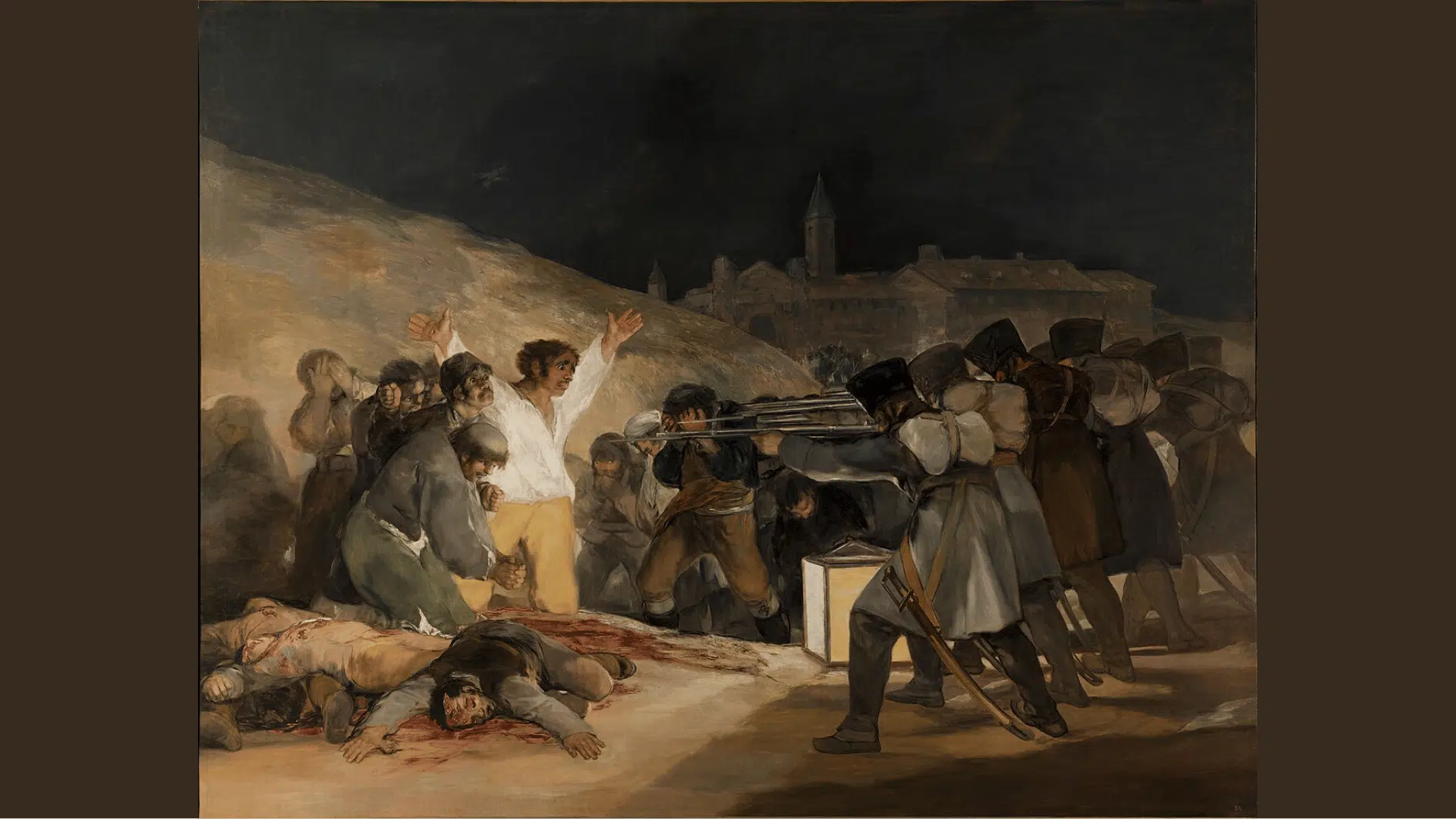 a man raises his arms before a firing squad at night with bloodied bodies of the already executed nearby